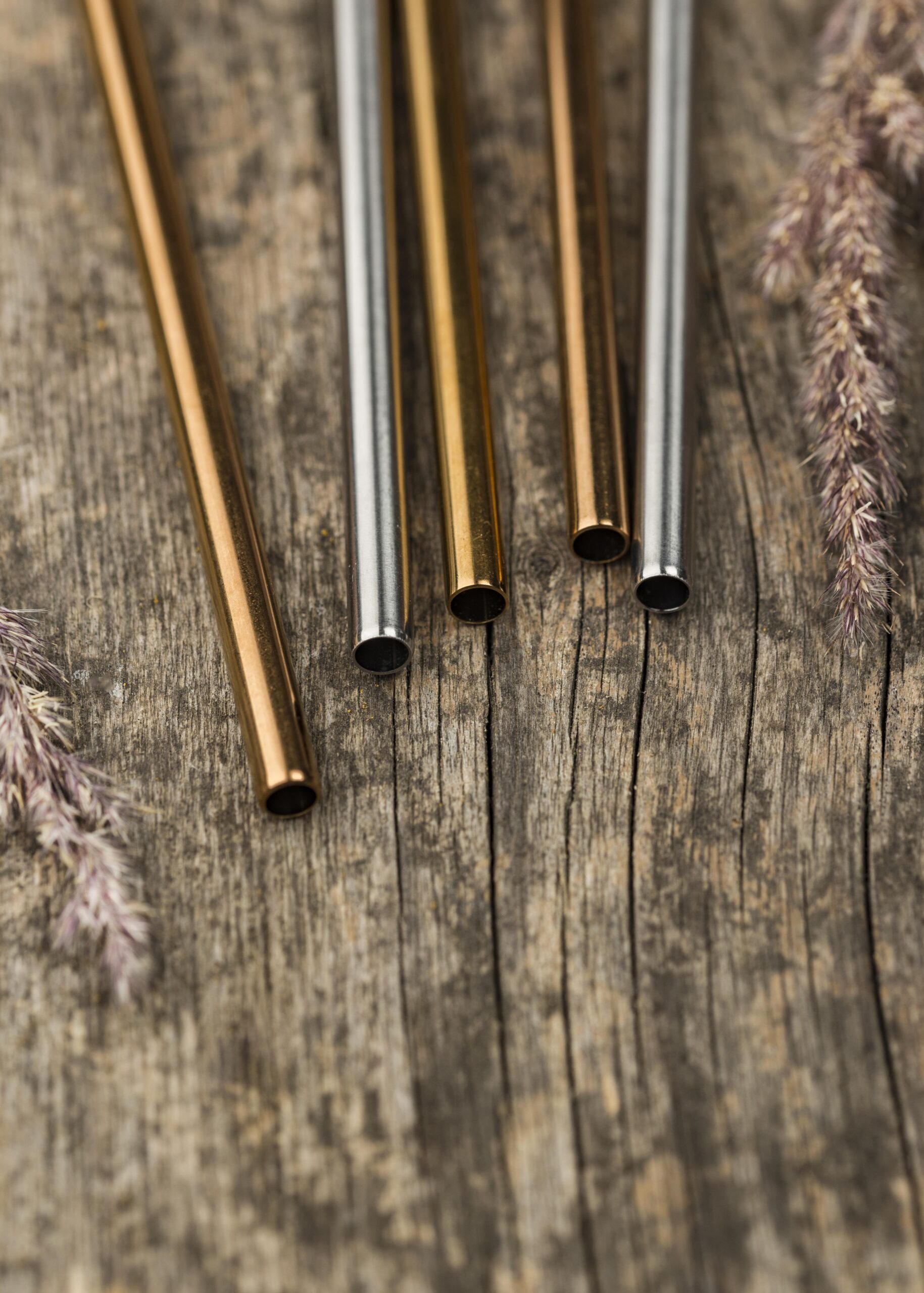 stainless metallic straws wooden background scaled